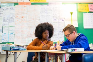 two students working together at desks in a classroom two students working together at desks in a classroom